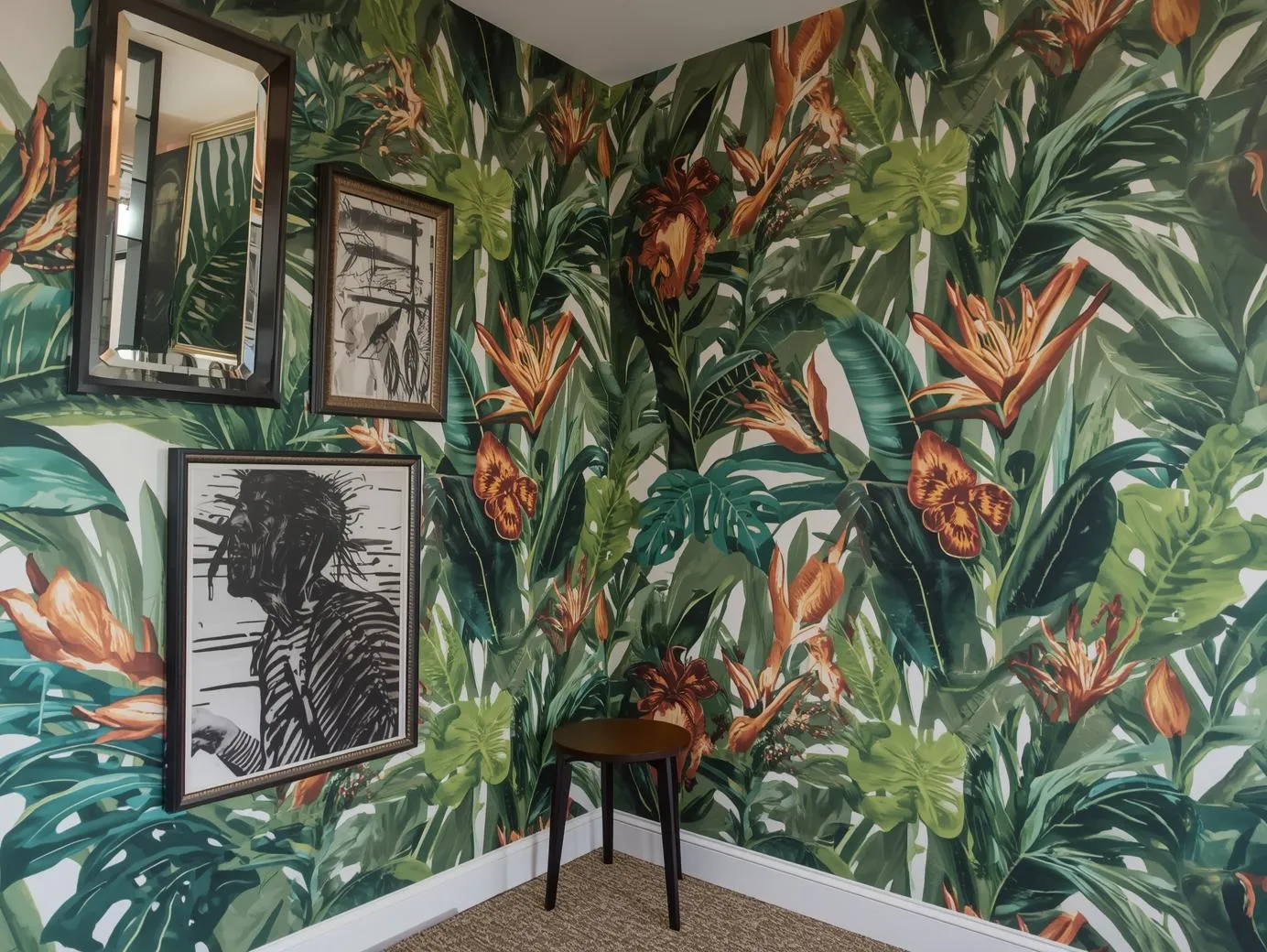  A living room featuring bold botanical wallpaper for tropical jungle living room style.